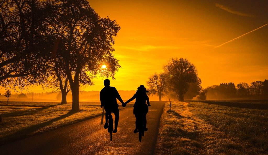 Couple holding hands on a Bike Ride