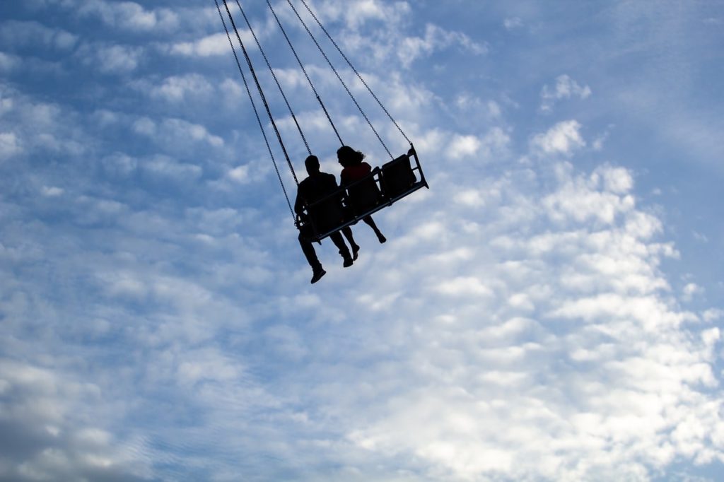 couple on swing ride at fair