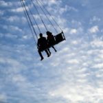 couple on swing ride at fair