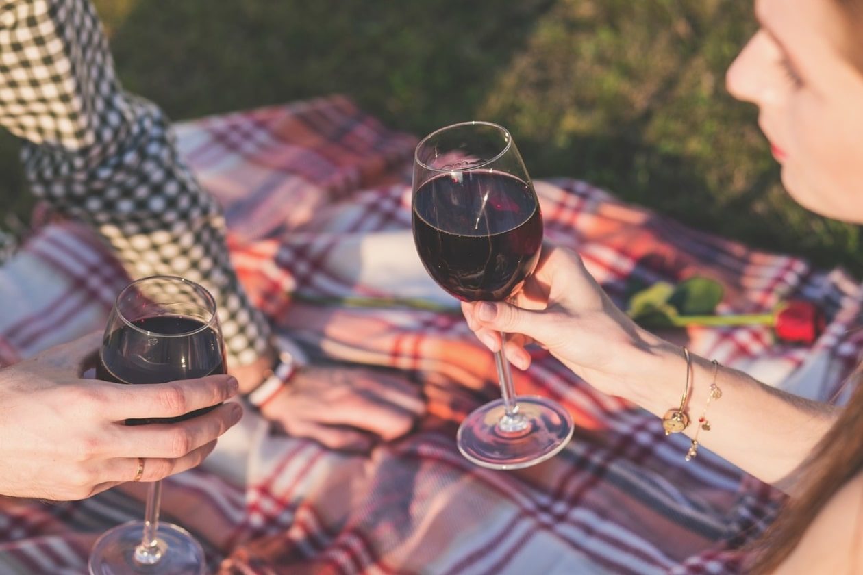 Couple on a picnic date with wine