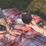 Couple on a picnic date with wine