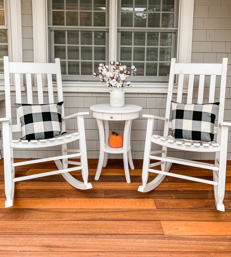 White rocking chairs with black and white checkered pillows