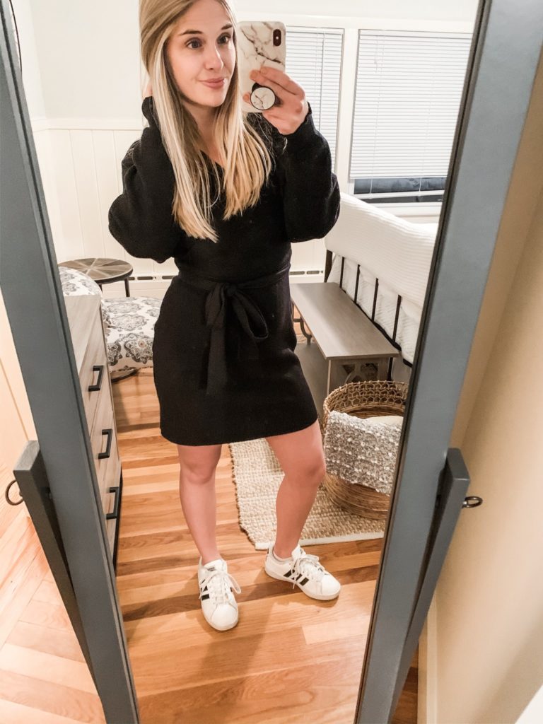 Girl in a sweater dress and sneakers