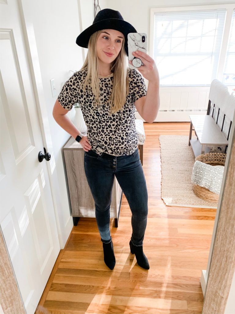 girl in leopard print shirt, a black hat, black jeans and boots