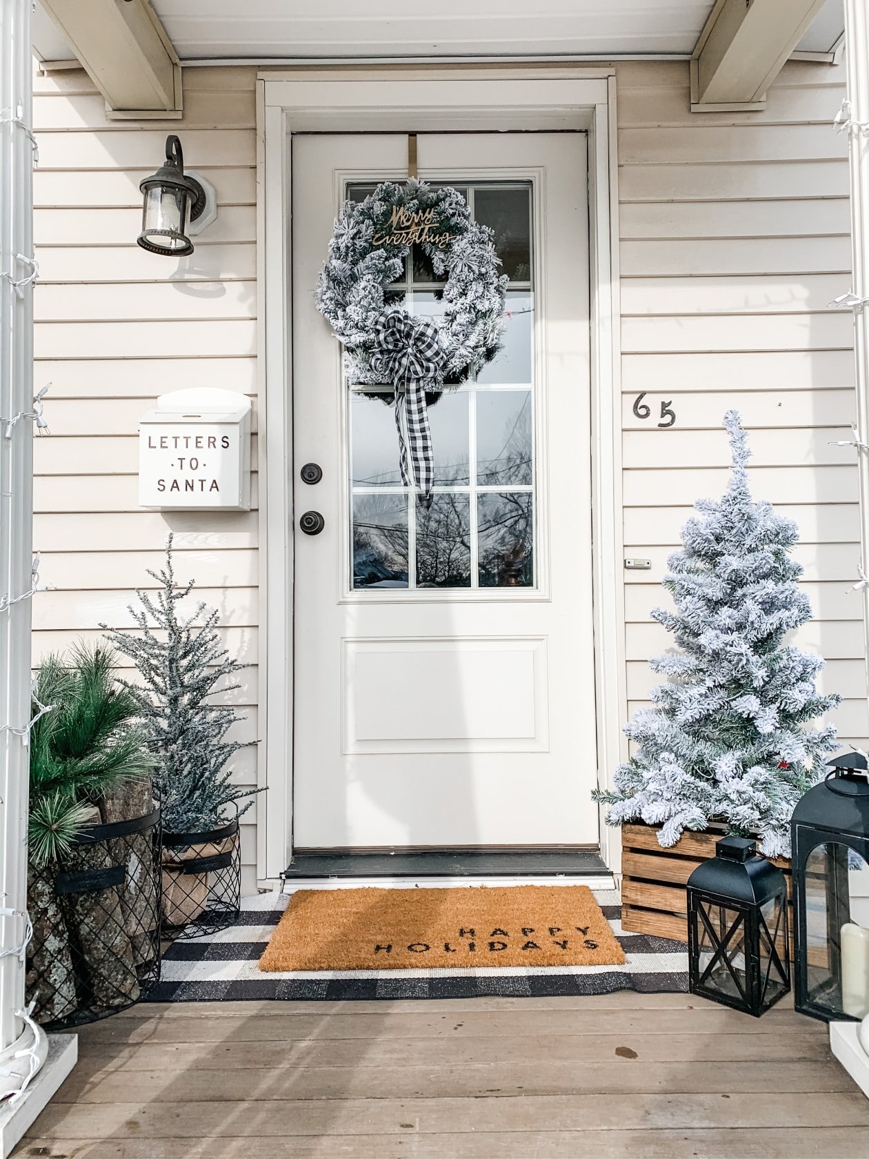 Farmhouse Winter Porch with Flocked Trees, logs, and metal baskets