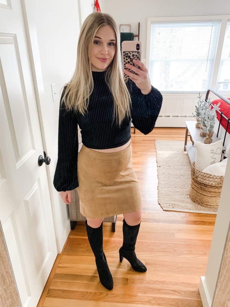 Girl in black crop top, skirt, black boots