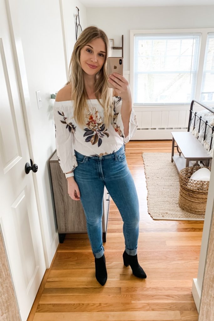 girl wearing white floral off the shoulder top and jeans with black boots