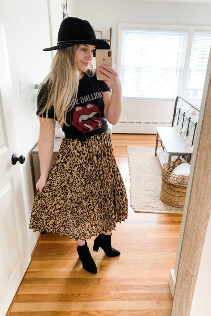 Girl wearing leopard print pleated skirt with rolling stones tshirt