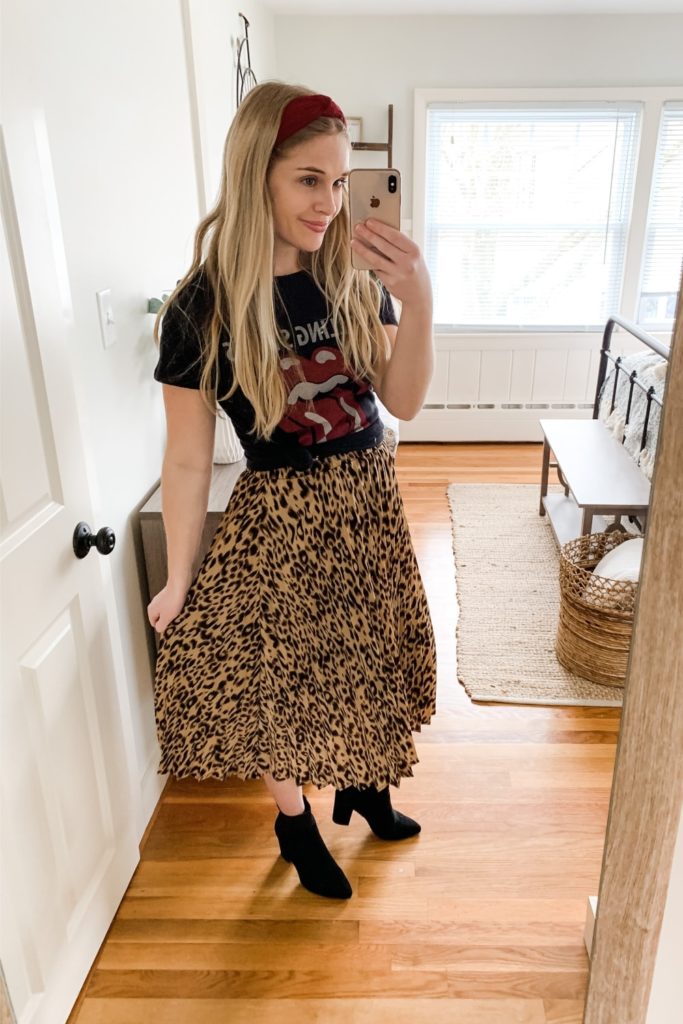 Girl wearing leopard print pleated skirt with rolling stones tshirt