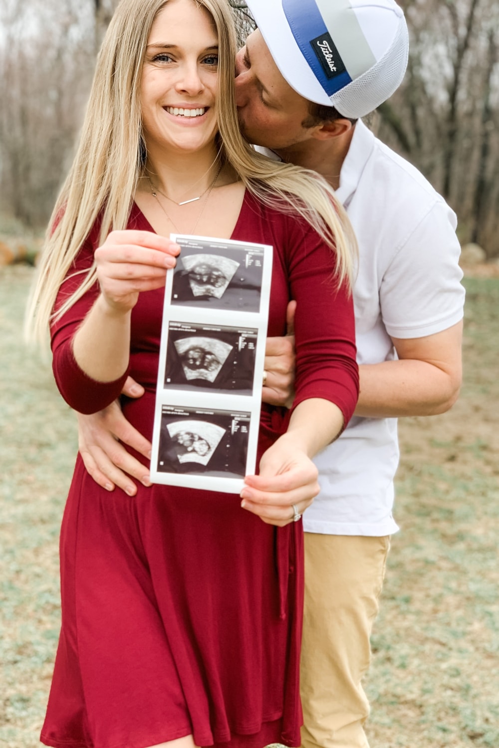 pregnancy announcement, couple holding ultrasound pictures