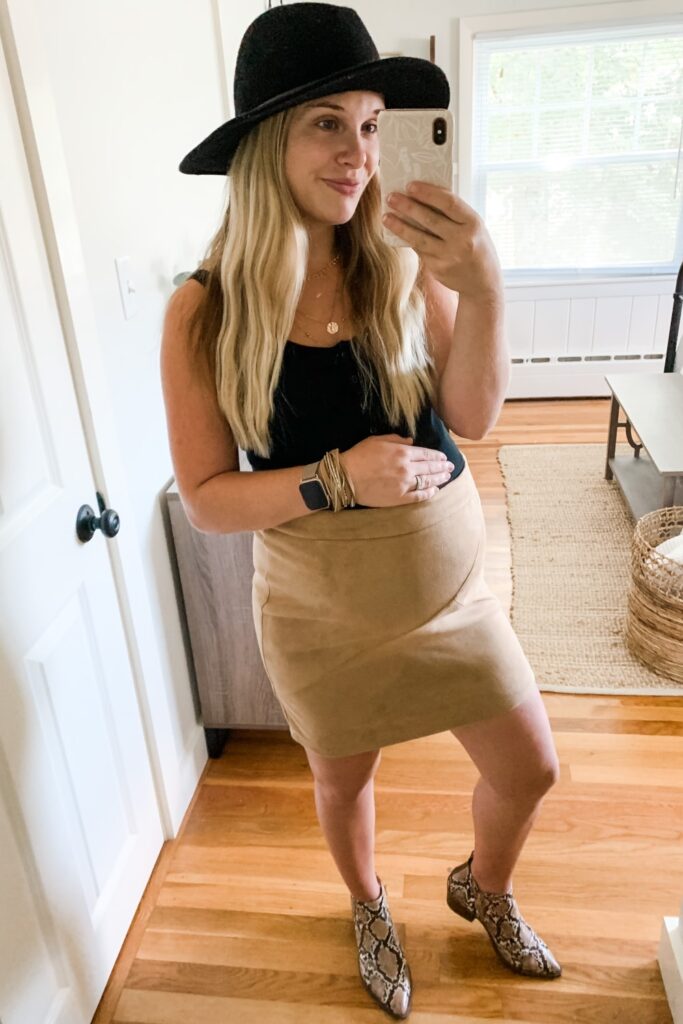 bump style: girl in snake skin booties, suede tan skirt, black tank top and a black hat