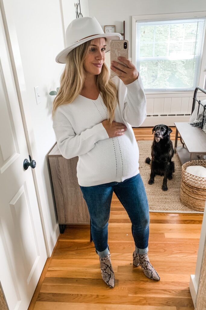 White knit off the shoulder sweater from Amazon with a white fedora hat and snake print booties