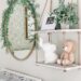 Round Gold rimmed mirror with flocked garland and 2 tiered wall shelf